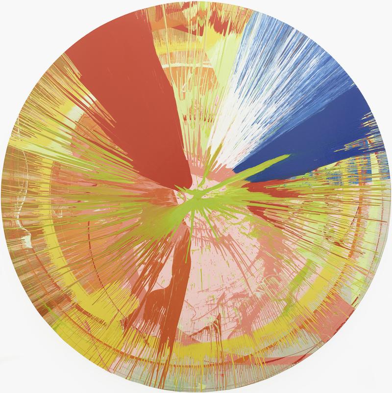 Das Kunstwerk zeigt ein großes, rundes Bild. Die Farben verlaufen in vielen Strahlen vom Mittelpunkt nach außen. Man sieht kräftiges Rot, Gelb, Blau, Grün, Rosa, Orange und Weiß. Die Farben wurden durch schnelle Drehung über die Fläche geschleudert worden.